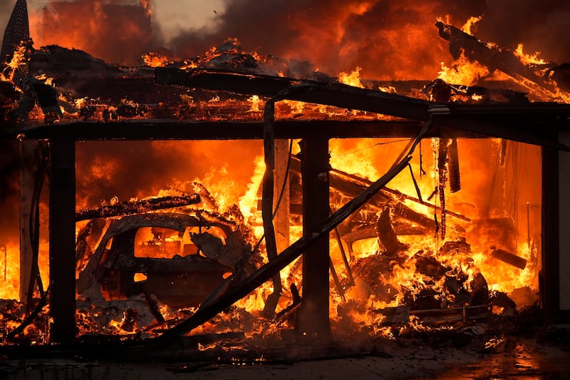 A home burns in the Mountain Fire in Camarillo, California (Marcio Jose Sanchez/AP)