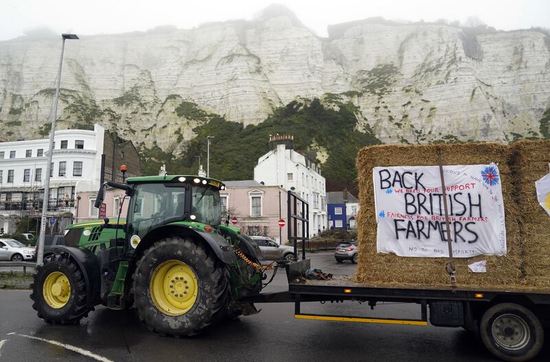 Farmers using their vehicles to protest against cheap meat imports drive past the Port of Dover in Kent