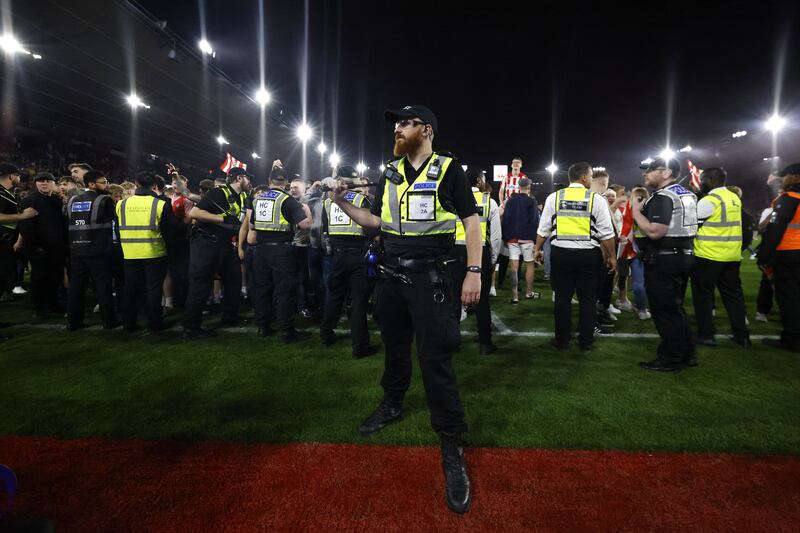 Police and ground staff attempt to separate the fans at St Mary’s