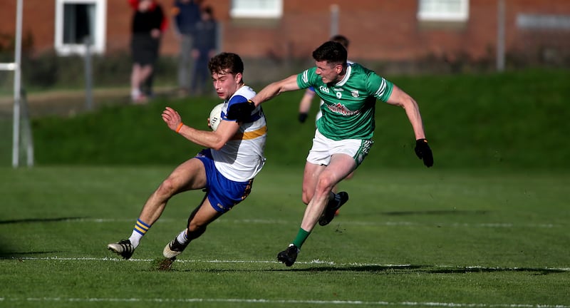 Errigal Ciaran's Odhran Robinson takes on  Cargin's John Carron at Corrigan Park.