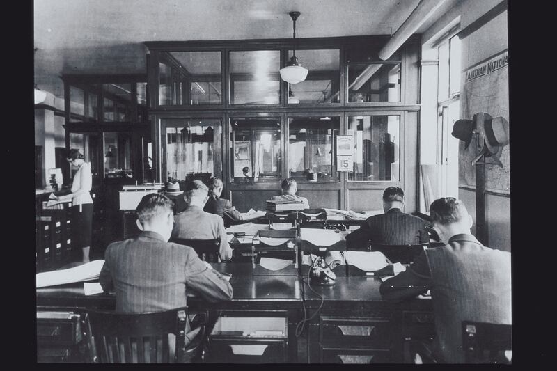 GROUP OF MALE CLERKS WORKING, CIRCA 1920S