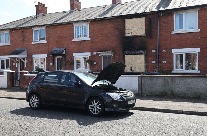 A car outside the property was set alight. PICTURE: COLM LENAGHAN