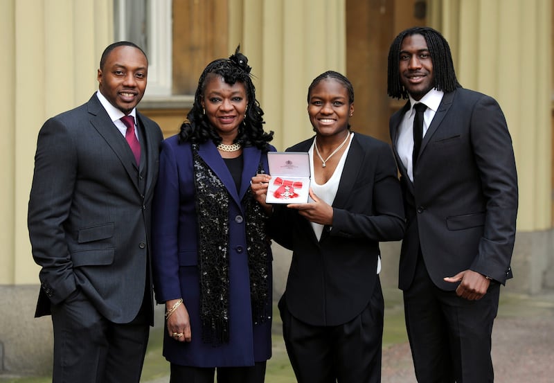 Nicola Adams, pictured with her family including her mother, after being made an MBE