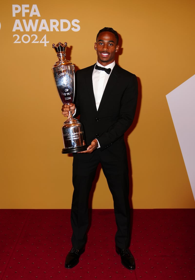 Crysencio Summerville with his PFA Championship Player of the Year trophy