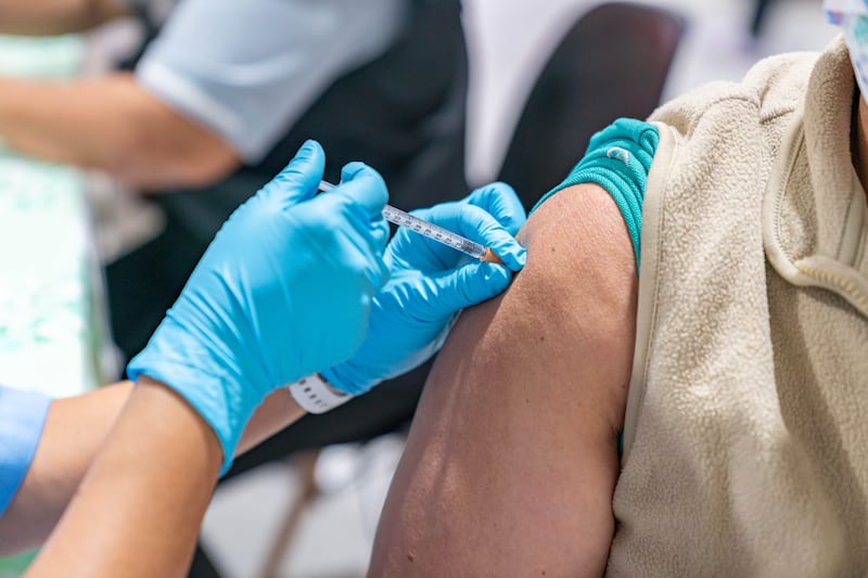 Close up photo of old woman getting vaccinated