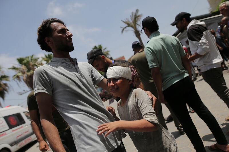 Palestinians wounded in the Israeli bombardment of the Gaza Strip arrive at al-Aqsa Hospital in Deir al Balah (AP)
