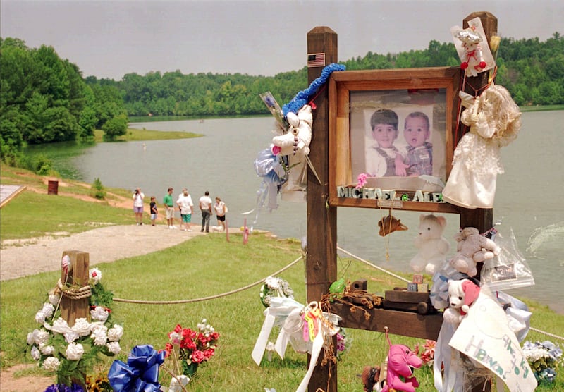 A tribute at the lake where Alex and Michael Smith were drowned in a car in 1994 (Lou Krasky/AP)