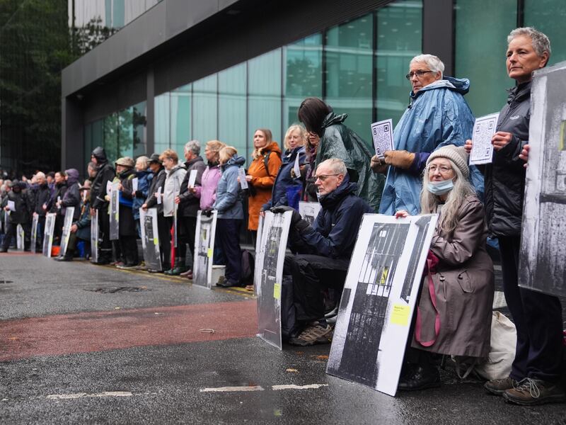 Just Stop Oil activists hold up banners of those jailed for previous activism outside Southwark Crown Court