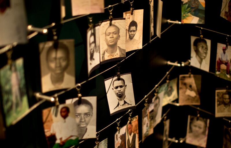 Family photographs of some of those who died hang in a display in the Kigali Genocide Memorial Centre in Kigali, Rwanda (AP Photo/Ben Curtis, File)