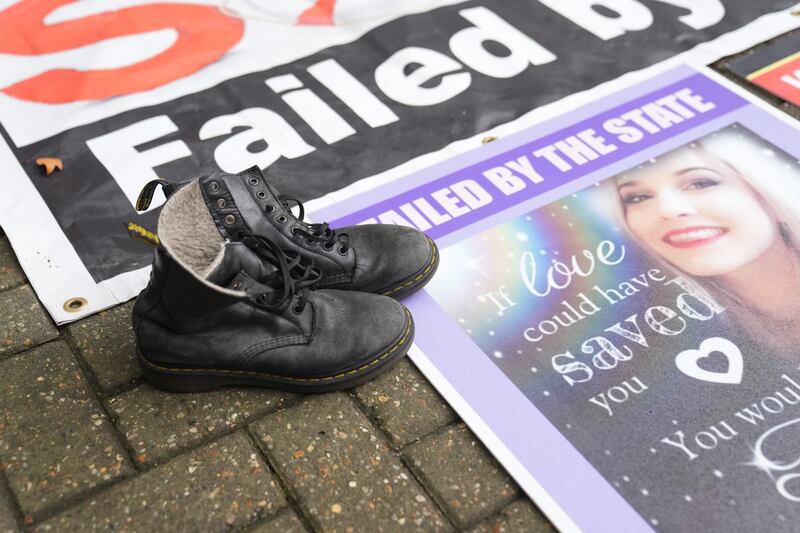 The boots of Tillie King, 21, laid next to her picture by her mother Lisa Bates, 57, who found her daughter dead in her bedroom in Brentwood, Essex in 2020