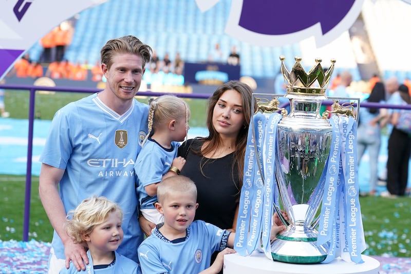 De Bruyne poses for a photo with wife Michele Lacroix, their children and the Premier League trophy