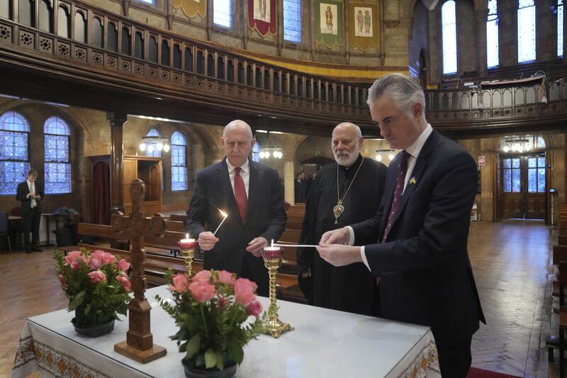 Defence Secretary John Healey, Bishop of Ukraine Diocese Kenneth Nowakoski and shadow secretary of defence James Cartlidge light candles