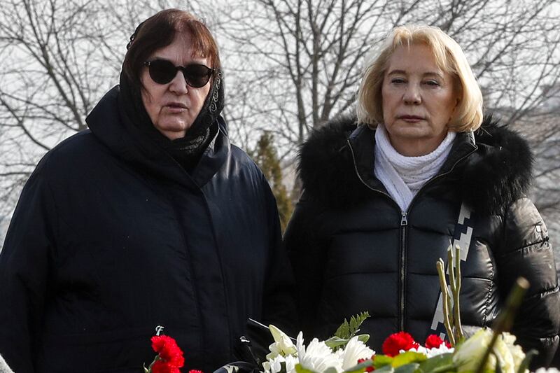 Russian opposition leader Alexei Navalny’s mother, Lyudmila Navalnaya, left, and his mother-in-law, no name available, visit the grave (AP)