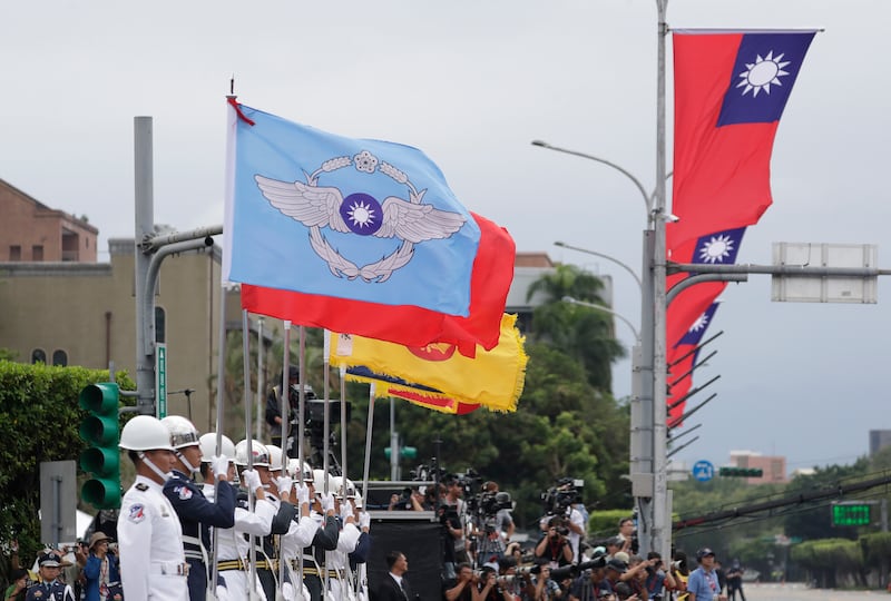 A military honour guard attends National Day celebrations in front of the Presidential Building in Taipei, Taiwan (Chiang Ying-ying/AP)