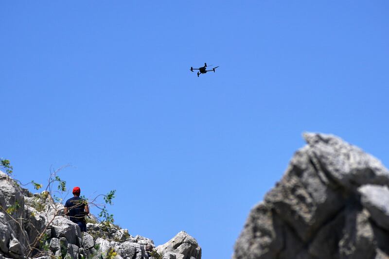A member of the search team flying a drone in Symi