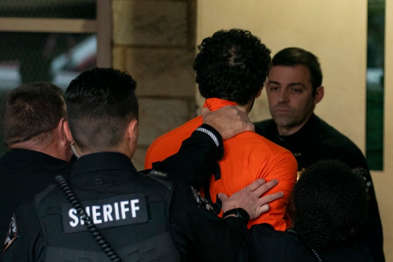 Suspect Luigi Mangione is taken into the Blair County Courthouse (Benjamin B Braun/Pittsburgh Post-Gazette via AP)