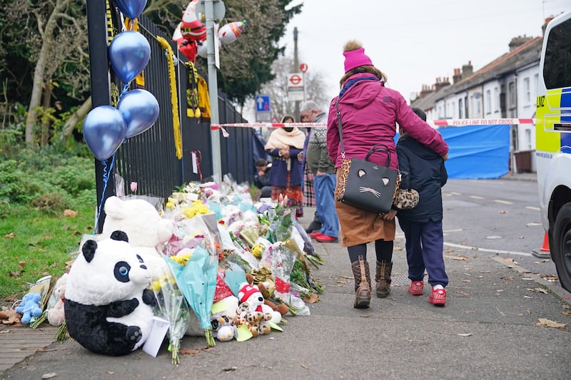 Flowers and toys are left near the scene of the fatal fire in Sutton, south London