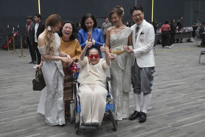 Rungtiwa Thangkanopast, fourth from right, and Phanlavee, right, whose photo was taken on condition of anonymity of the last name, pose for a group photo with other family members after the Marriage Equality Act took effect in Bangkok, Thailand (Sakchai Lalit/AP)