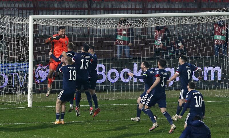 David Marshall celebrates saving from Serbia’s Aleksandar Mitrovic with his Scotland team-mates