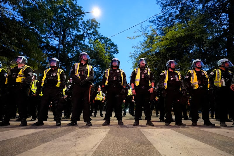 Police watch as protesters march during a demonstration near the Democratic National Convention (Alex Brandon/AP)