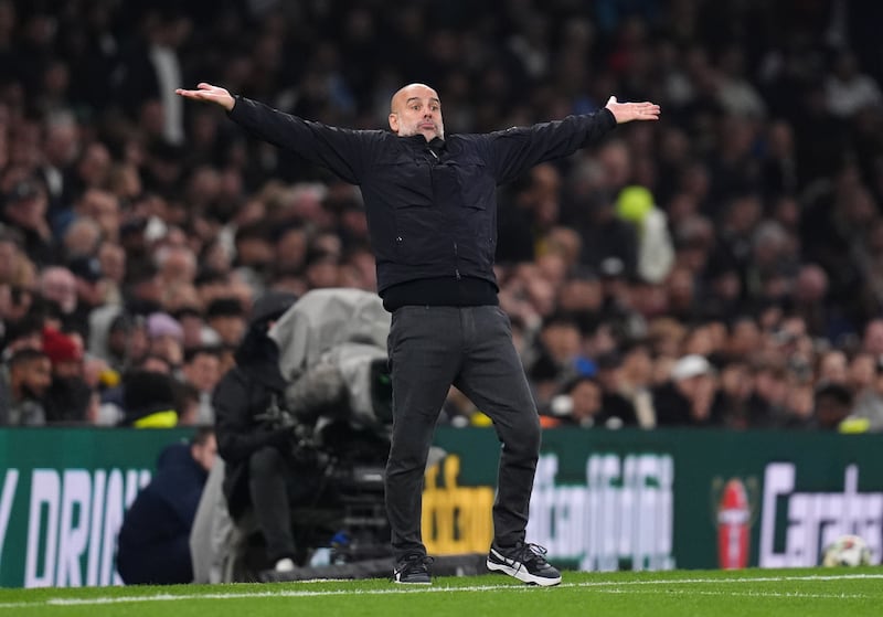 Pep Guardiola gestures during the Carabao Cup loss to Tottenham