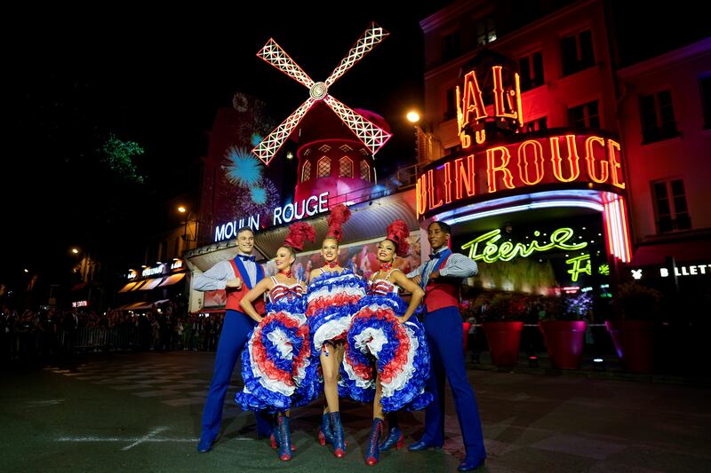 Dancers perform in front of the Moulin Rouge cabaret (Thibault Camus/AP)