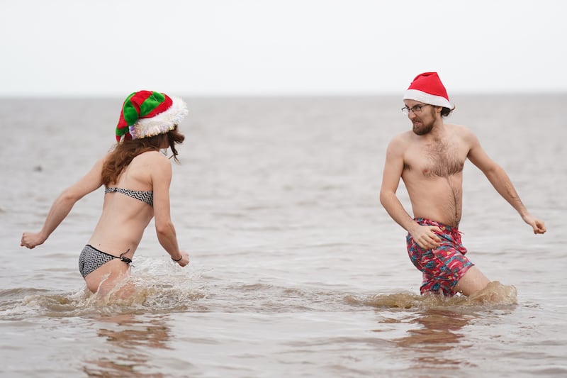 People take part in a Christmas Day dip at Hunstanton in Norfolk