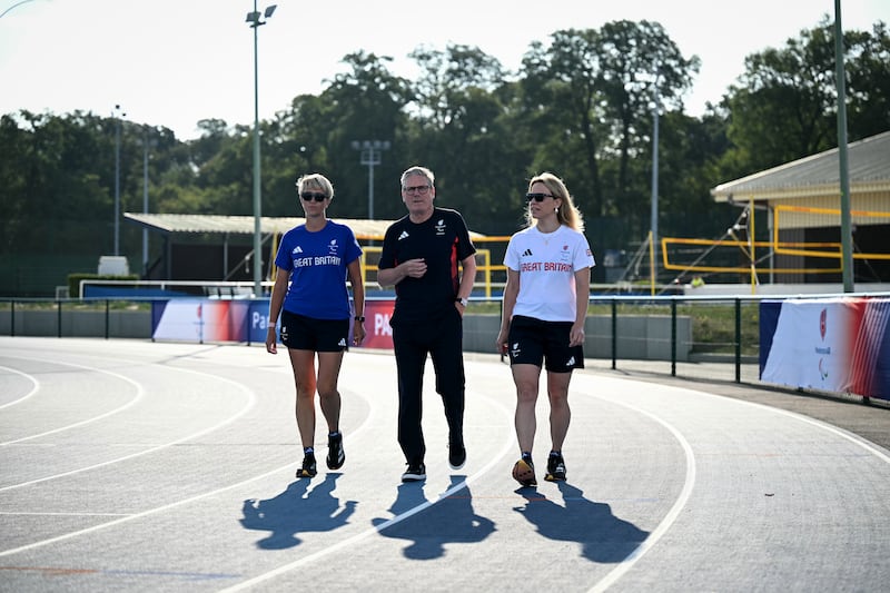 Sir Keir Starmer with Team GB’s team manager for athletics Pamela Robson (left) and head of preparations Maria Adey (right) at a training centre in Saint-Germain-en-Laye