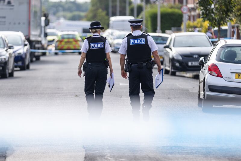 Police officers near the scene in Hart Street, Southport,