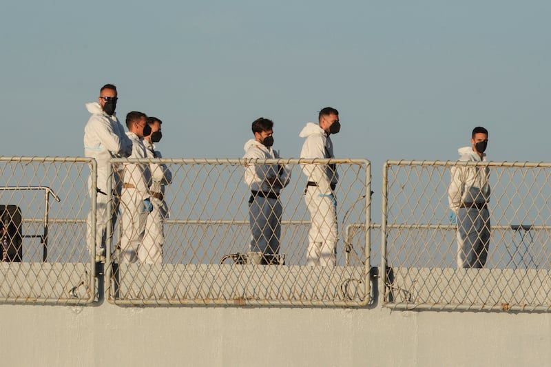 Security officials on the Italian navy ship Libra as it arrives at the port of Shengjin on Wednesday (Vlasov Sulaj/AP)