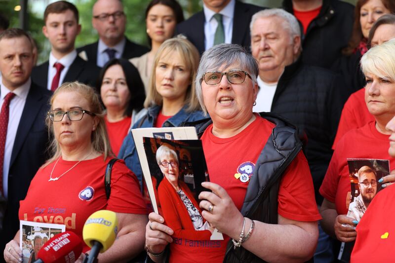 Brenda Doherty of Northern Ireland Covid-19 Bereaved Families for Justice holds a photo of her late mother Ruth Burke outside the Clayton Hotel in Belfast