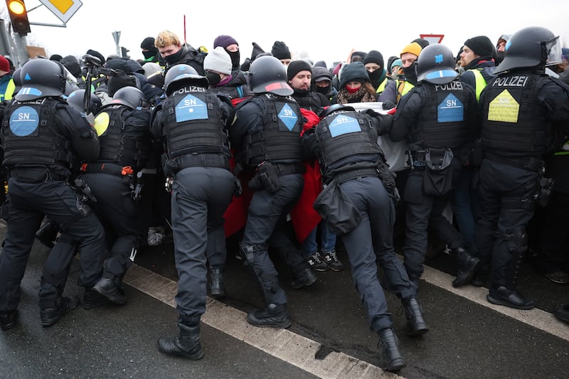 Police push back protesters to stop a demonstration against the AfD’s national party conference (Jan Woitas/dpa/AP)