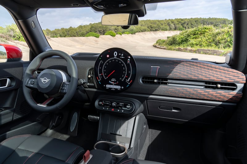 The interior features sports seats and steering wheel. (Mini)