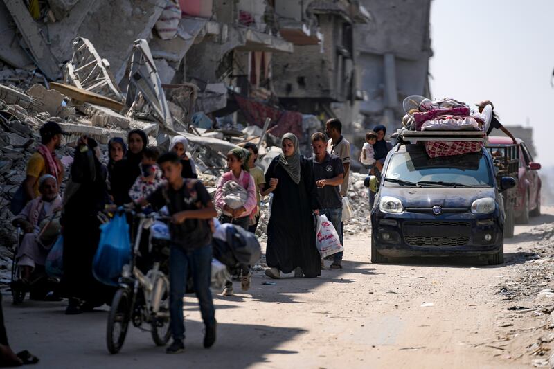 Palestinians displaced by the Israeli air and ground offensive on the Gaza Strip flee from parts of Khan Younis (Abdel Kareem Hana/AP)