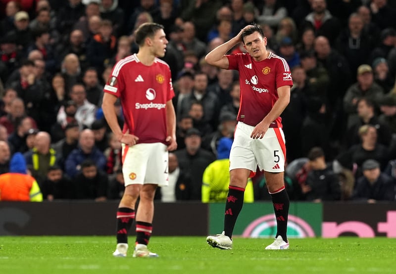 Harry Maguire, right, looks frustrated after Twente’s Sam Lammers equalises