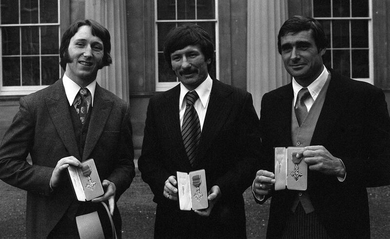 JPR Williams, left, alongside Tommy Smith, the former Liverpool footballer and tennis star Roger Taylor at Buckingham Palace after receiving their MBEs