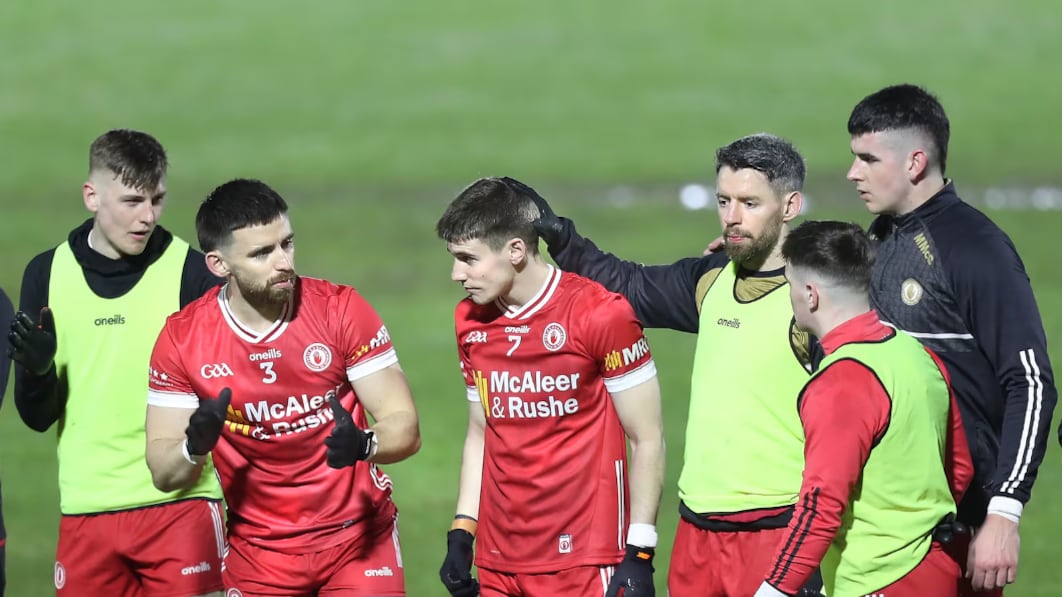 Niall Devlin, in the number 7 jersey, is consoled by Tyrone teammates ahead of playing against Monaghan a week after the funeral of brother Caolan. PICTURE: MARGARET MCLAUGHLIN
