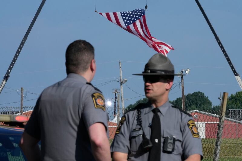 Police officers stand at a road leading to the site of the Trump rally in Butler, Pennsylvania (Sue Ogrocki/AP)