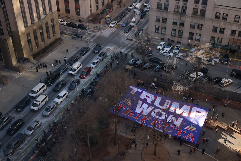 Supporters of Mr Trump display a banner outside Manhattan criminal court during the sentencing hearing in his hush money case on Friday (Yuki Iwamura/AP)