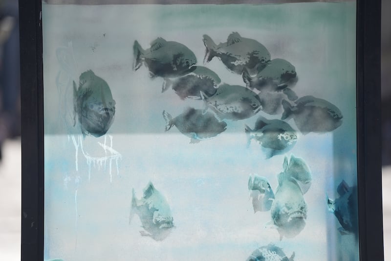 The artwork on the police box differs from Banksy’s previous silhouette designs as the fish have been painted with more detail and tone