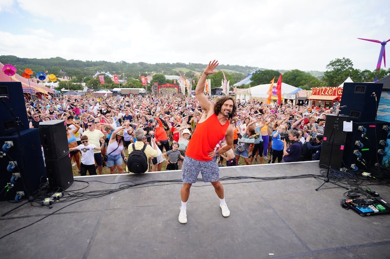 Joe Wicks leading a crowd at Glastonbury Festival in a workout