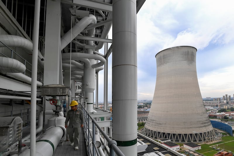 A worker inspects facilities at a coal-fired power plant in Wuhan in central China’s Hubei province (Chinatopix/AP)