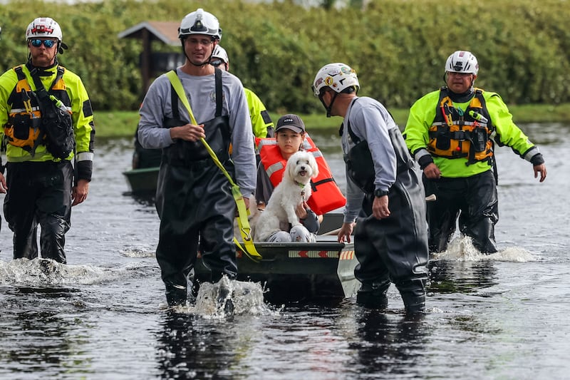 Rescue workers continued to help residents to evacuate the hardest hit areas (Mike Carlson/AP)