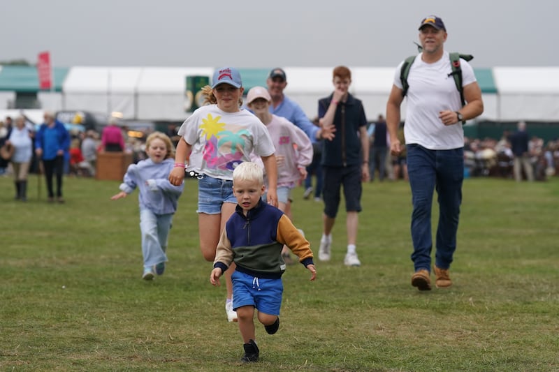 The three children ran around the event with their father in tow