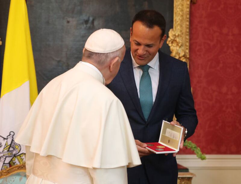 Pope Francis presents Taoiseach Leo Varadkar with a gift in Dublin Castle. Picture by Niall Carson, Press Association