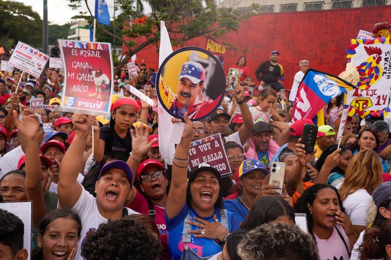 Supporters of Venezuelan President Nicolas Maduro attend a campaign rally in the Catia neighbourhood of Caracas (Matias Delacroix/AP)