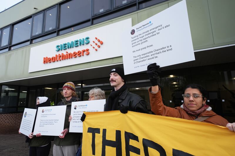 Activists from Fossil Free London and Green New Deal Rising protest against airport expansion plans outside Siemens Healthineers in Eynsham, Oxfordshire