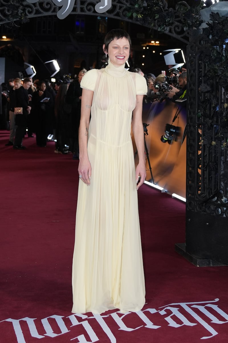 Emma Corrin wore a see-through yellow gown by British designer Alexander McQueen