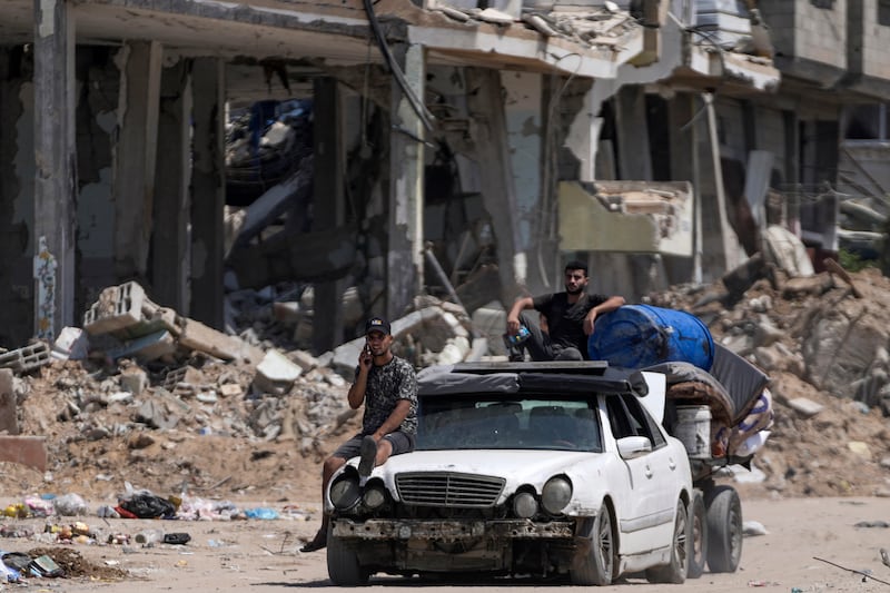 Palestinians evacuate Maghazi refugee camp in the central Gaza Strip, as part of a mass evacuation ordered by the Israeli military ahead of an operation (Abdel Kareem Hana/AP)