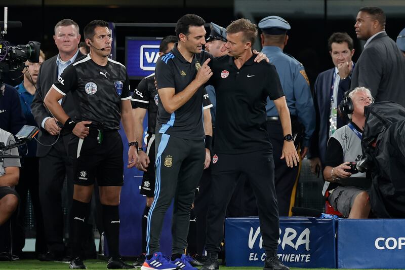 Argentina’s coach Lionel Scaloni, centre left, embraces Canada’s coach Jesse Marsch at the end of the Copa America semi-final (Adam Hunger/AP)